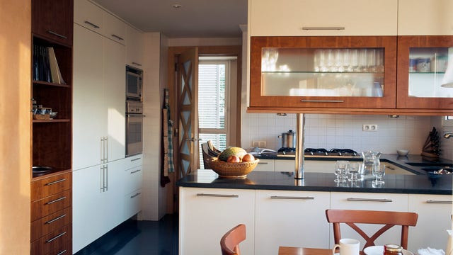 Woman finds bizarre symbols drawn behind kitchen cabinets prompting fears that house is cursed