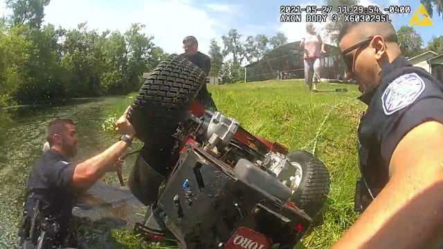 Florida police officers save man pinned under lawnmower in pond