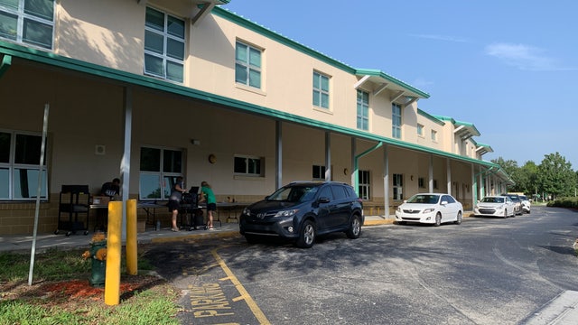 Parents pick up laptops, hotspots from Celebration school for remote learning