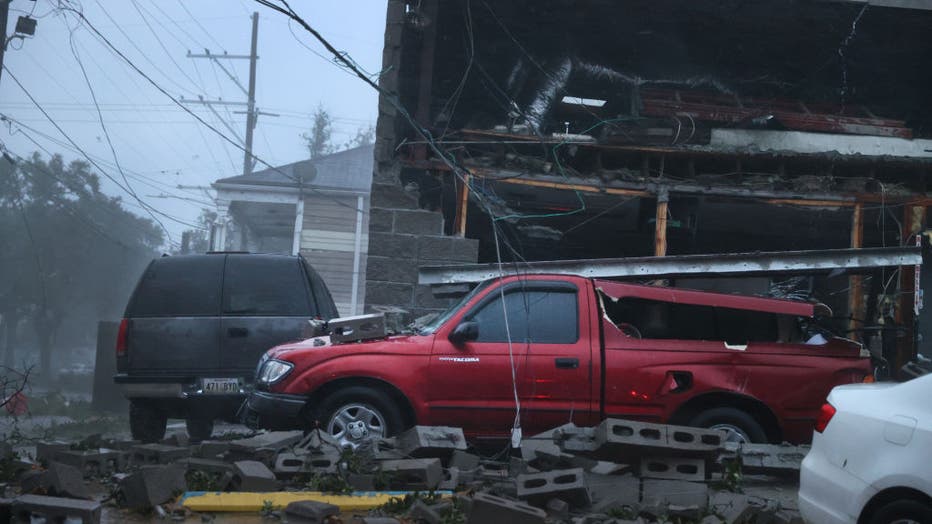 NEW ORLEANS, LOUISIANA - AUGUST 29: Vehicles are damaged after the front of a building collapsed during Hurricane Ida on August 29, 2021, in New Orleans, Louisiana. (Photo by Scott Olson/Getty Images)