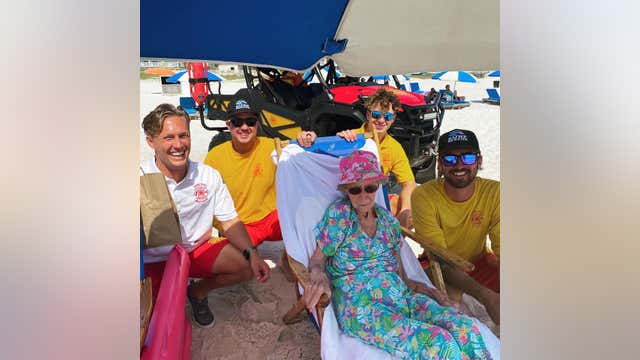 Alabama lifeguards help 95-year-old down to beach every day during her stay