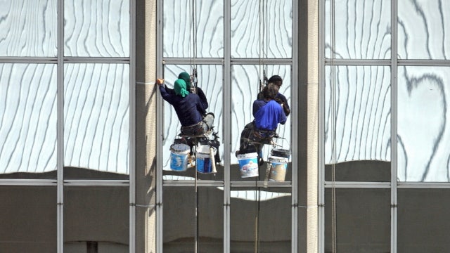 Painters rescued from 26th floor of Thailand high-rise after woman opened window, cut support rope