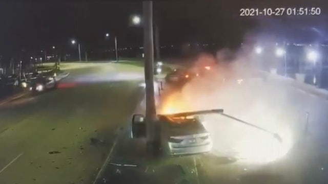 WATCH: Car speeds past Florida officers before crashing into pole, bursting into flames