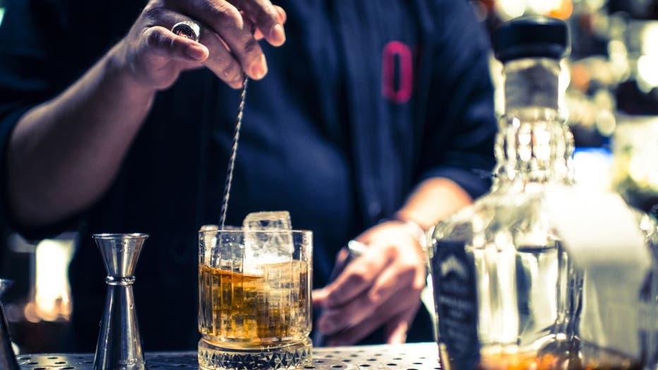 FILE - A bartender makes a drink at a cocktail bar in Milan, Italy. (Photo by: De Simone Lorenzo/AGF/Universal Images Group via Getty Images)