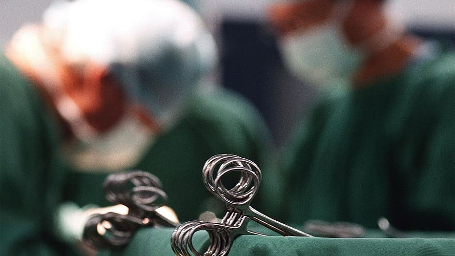 FILE IMAGE - Surgeons are pictured in the background in an operating room. (Photo by Fairfax Media via Getty Images via Getty Images)