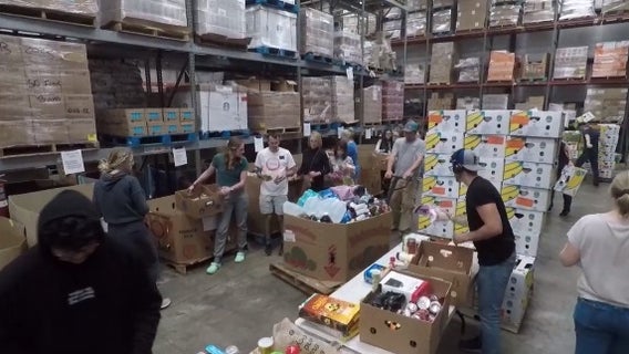 Volunteers at Southeastern Food Bank help pack Thanksgiving meals for families in need