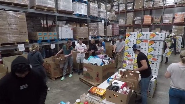 Volunteers at Southeastern Food Bank help pack Thanksgiving meals for families in need