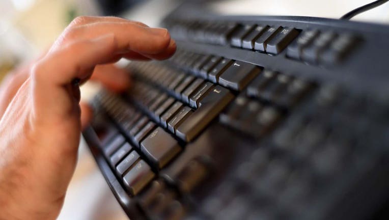 Man types on keyboard