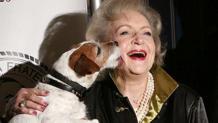 FILE - Actress Betty White and Uggie the dog attend The Friars Club Salute To Betty White at Sheraton New York Hotel & Towers on May 16, 2012, in New York City. (Photo by Jim Spellman/WireImage)