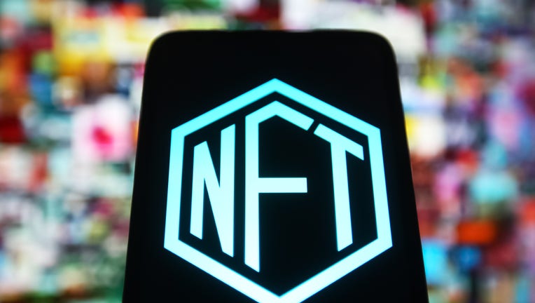 In this photo illustration, a NFT (Non-fungible token) sign