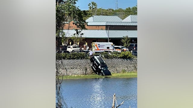 Vehicle submerged in pond with occupants in Orange City