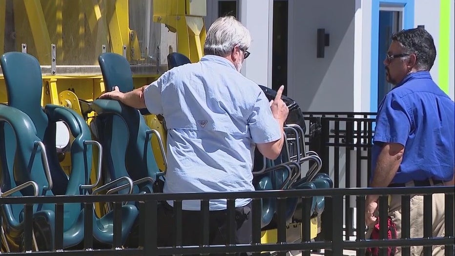 An inspector with the Florida Department of Agriculture and Consumer Affairs, the state agency that oversees the safety of amusement rides, looks over the Orlando Free Fall drop tower ride at Orlando ICON Park. (Credit: FOX 35 Orlando)