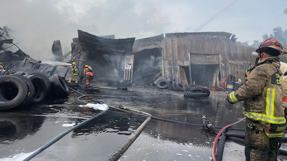 Tires burn in huge fire at Florida auto shop in Orange County