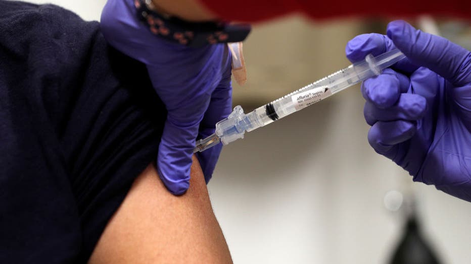 LVN Ilda Villahermosa, right, injects Melanie Valdez with a flu vaccine shot at the Kaiser Permanente Redwood City hospital in Redwood City, Calif., on Thursday, December 28, 2017