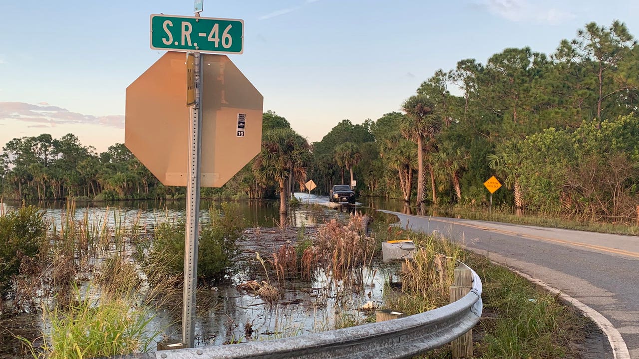 Florida's 'Water Uber' hero tows neighbors through flooded street to get to work, school