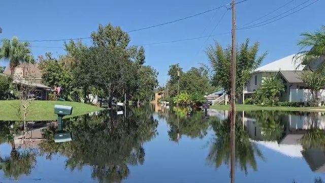 'Your whole life is disrupted': Florida residents commute to homes by canoe through flooded neighborhoods