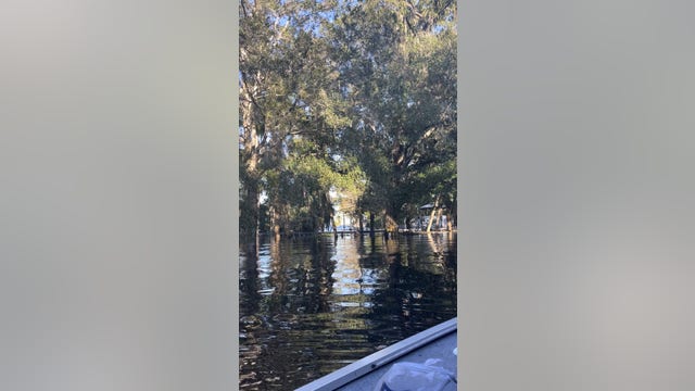 Florida man drowning in ditch saved by others who were hauling out flooded items