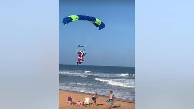 It's a bird! It's a plane! It's Santa Claus parachuting onto a Florida beach