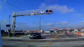 Driver appears to be going through crossing arm seconds before train stops