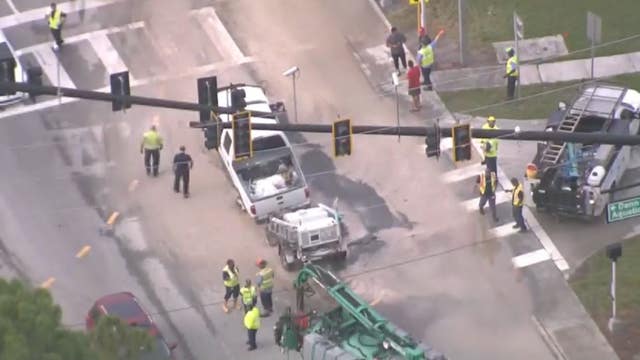 Large hole nearly swallows pickup truck in Kissimmee amid watermain rupture
