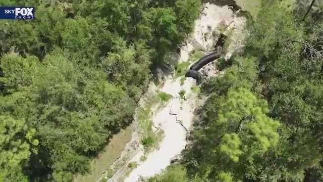 Neighbors frustrated with massive hole alleged to be caused by poorly built drainage system