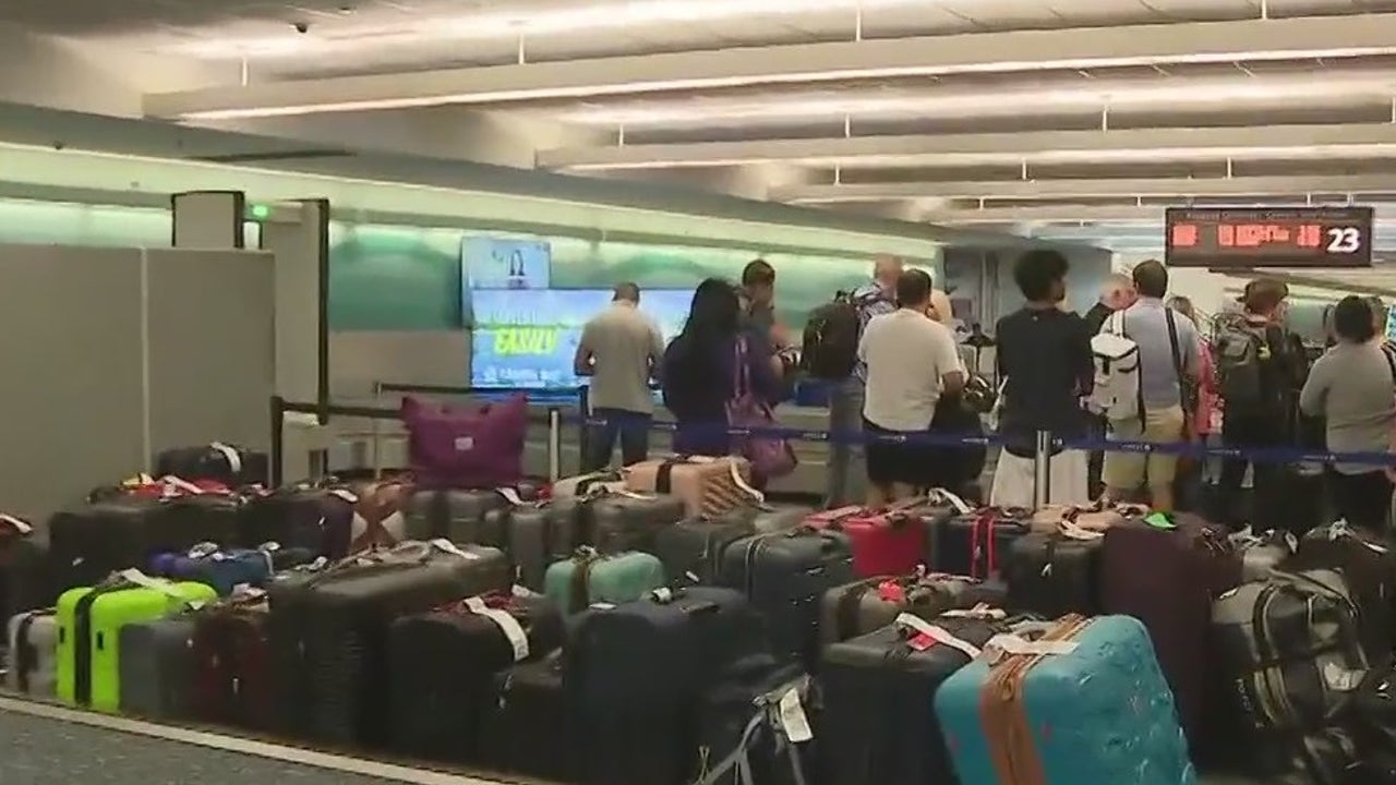 Hundreds of bags wait for delayed travelers flying to Orlando International Airport