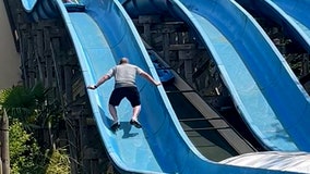 Father scales waterslide to rescue his stuck daughter, video shows