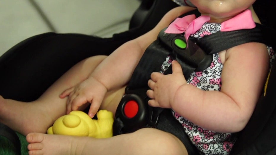 File: Baby girl in car seat