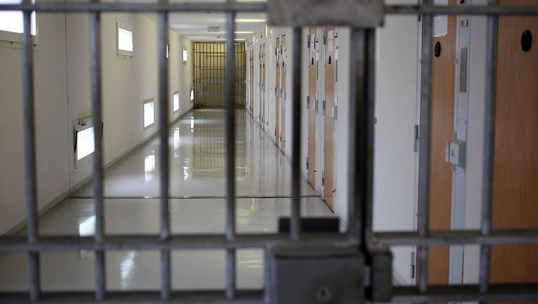 FILE - Stock image of a jail cell looking into a hallway.