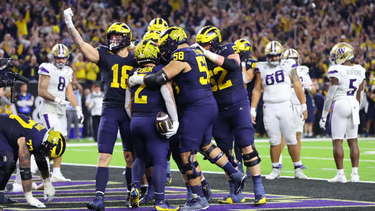 Corum scores 2 TDs Michigan overpowers Washington 34 13