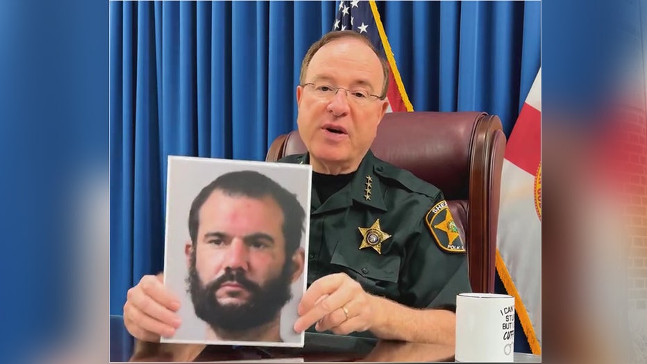 Polk County Sheriff Grady Judd holds up an image of Mark Byram. Image is courtesy of the Polk County Sheriff's Office.