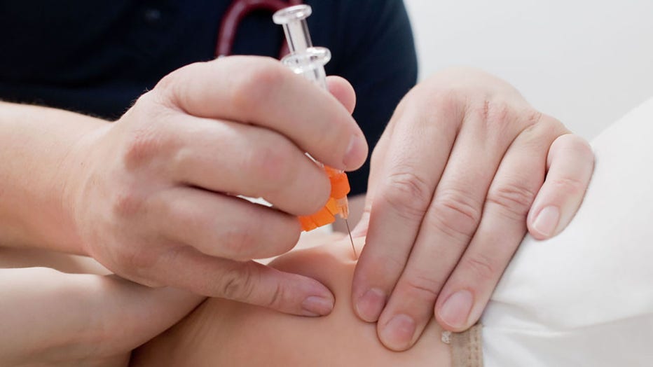 FILE - A pediatrician vaccinates a child with the vaccine Bexsero (group B meningococcus). (Photo by Julian Stratenschulte/picture alliance via Getty Images)