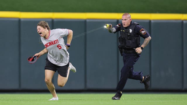 Reds fan tased and arrested after running onto field and doing backflip in front of officer