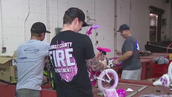 Seminole County firefighters assemble bikes for children in need