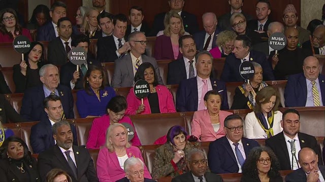 Democrat signs during Trump speech: 'Musk Steals,' 'Save Medicaid'