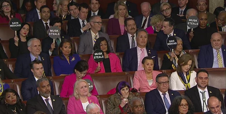 Democrat signs during Trump speech: 'Musk Steals,' 'Save Medicaid'