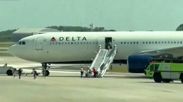 Delta plane catches fire in Orlando: Passengers claim only one emergency slide was used