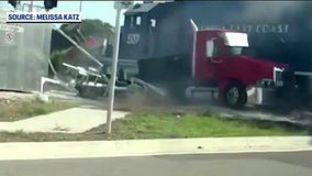 Freight train slams into semi-truck stalled on tracks in Florida