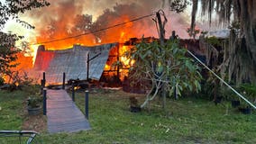 Firefighters battle large, deadly house fire in Sanford