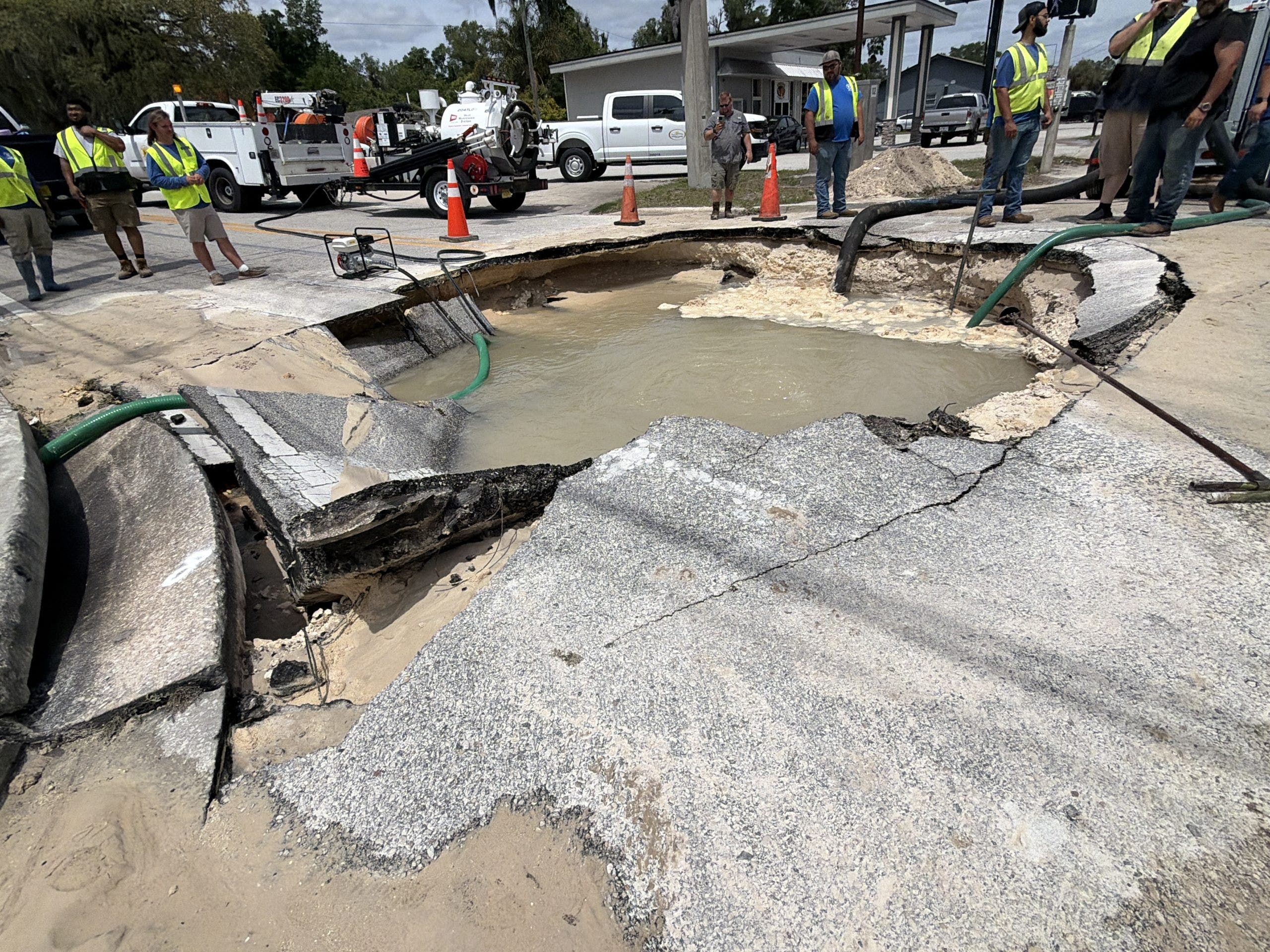 Water main break opens large crater, closes DeLand road