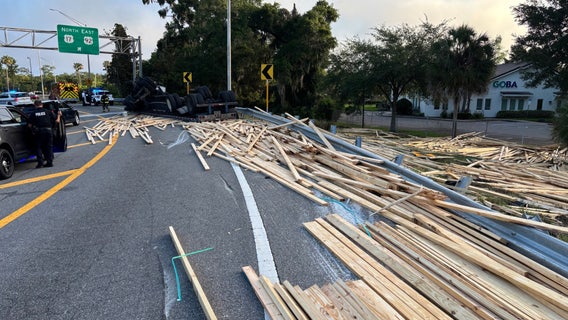 Tractor-trailer overturns, spills lumber onto Maitland road