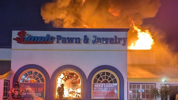 Photos: Massive fire at Kissimmee pawn shop; 1 firefighter hurt, official says