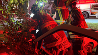 Fire crews free 2 people trapped in pickup truck after crash, wedged between fence, tree
