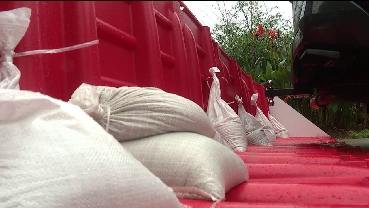 Florida woman flood proofs home with berm , pipes , pumps and portable barriers