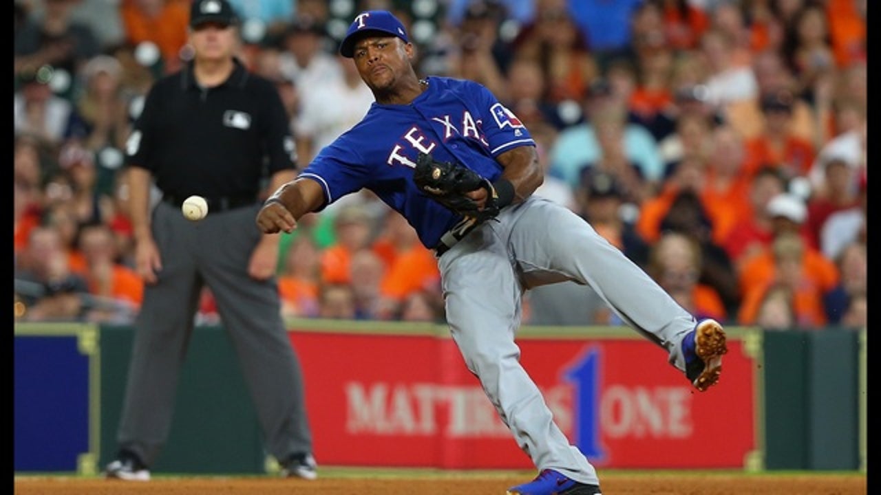 The Texas Rangers' Adrian Beltre and his son, Adrian Jr., 8, walk out