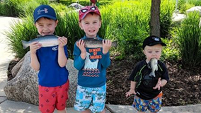 Mom photographs candid moment with sons, doesn't realize one has fish stuck in his mouth
