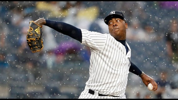 Chapman, Yankees weather heavy rain, hold off Rangers 5-3