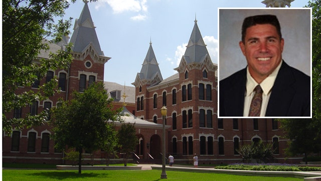 Baylor instructor holds student's fussy baby during class