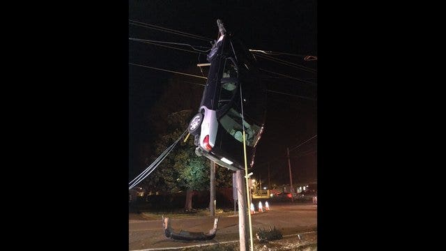 Car dangles from power lines after Tennessee crash