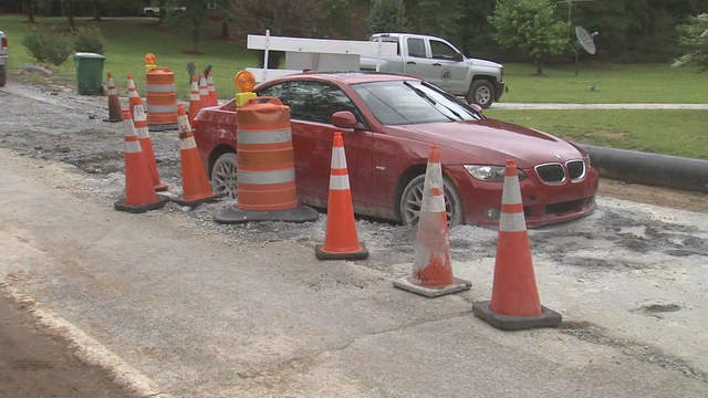 Woman upset after car stuck in wet cement